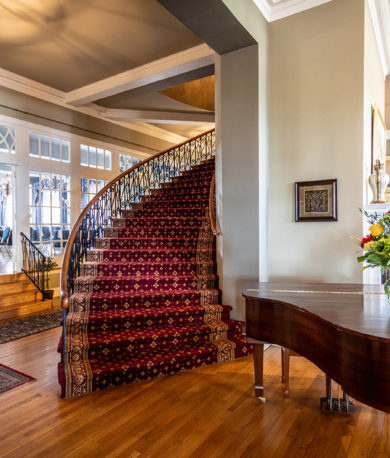 Lobby of the Mimslyn Inn, showing a piano and a spiral staircase