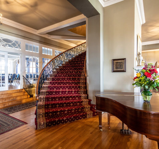 Lobby of the Mimslyn Inn, showing a piano and a spiral staircase