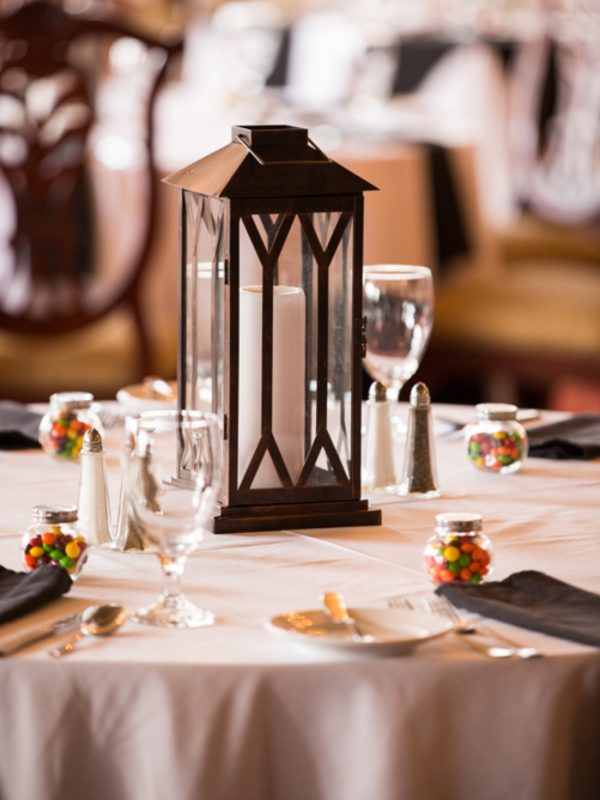Lantern on a table set for a wedding