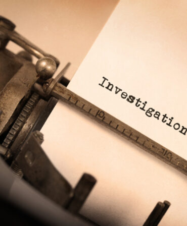 typewriter with writing "investigation"