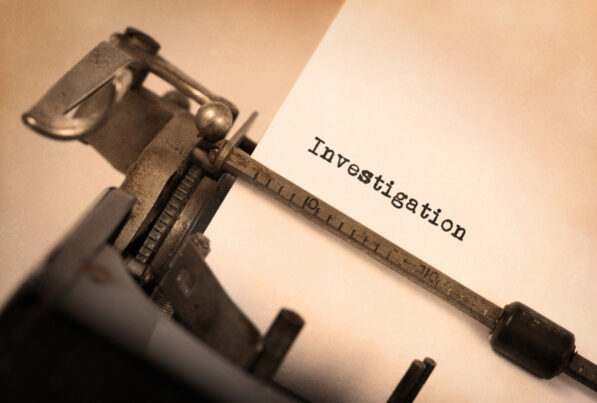 typewriter with writing "investigation"